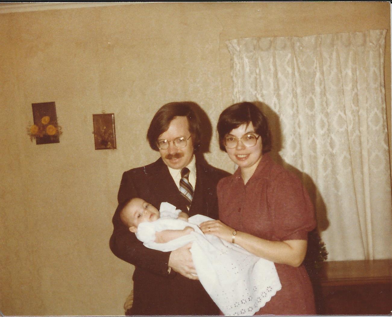 Bill, Marilyn and Sarah at Marilyn's
parents' home on the day of Sarah's baptism, December 1980