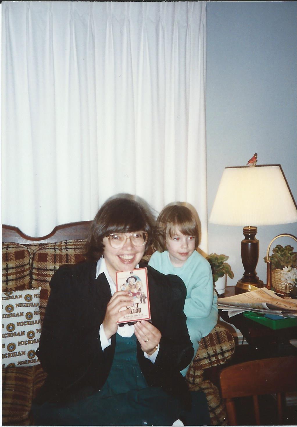Marilyn (holding a VHS copy of one of
the family's favorite movies) with Rebecca,
1990