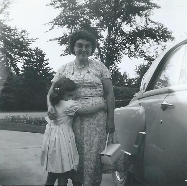 Marilyn Munsell hugging Ruth Weinmann Munsell next to the car
