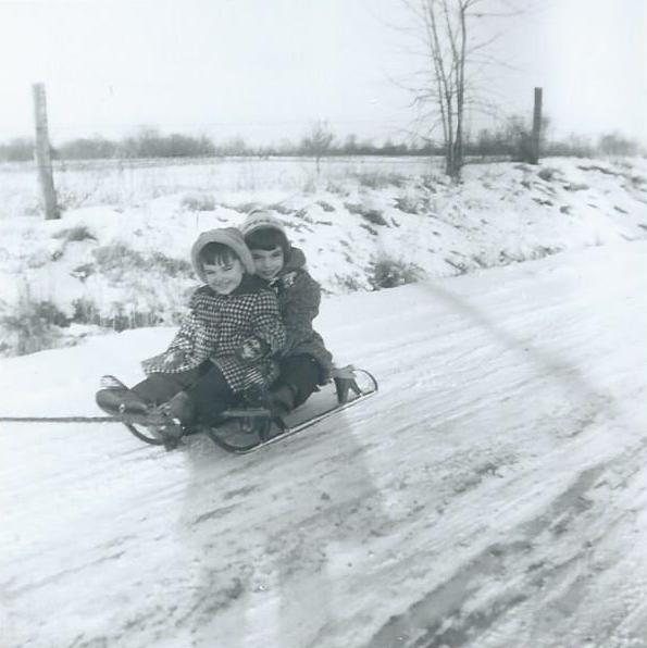John Munsell and Marilyn Munsell being pulled on a sled on Egypt Road