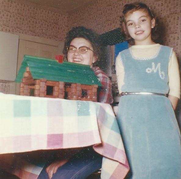 uth Weinmann Munsell and Marilyn Munsell in the kitchen with a Lincoln Log house