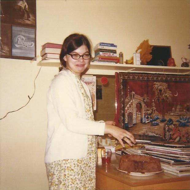 Marilyn Munsell serving cake at an Adrian College dormitory party