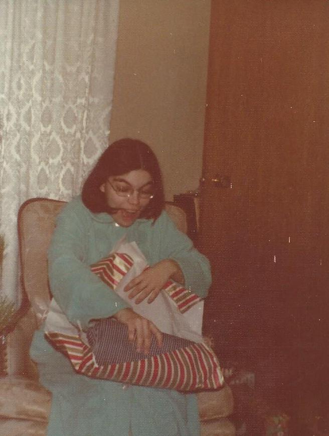 Marilyn Munsell opening a Christmas present